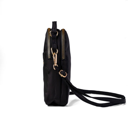 Black crossbody bag with gold zippers on a white background